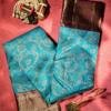 9 - 2026-09-03T174209.909 Rich Mayil blue body with intricate zari floral weaving, paired with a classic deep maroon antique gold border.