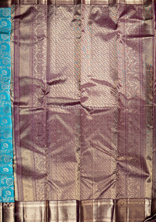 9 - 2026-09-03T174620.476 Rich Mayil blue body with intricate zari floral weaving, paired with a classic deep maroon antique gold border.